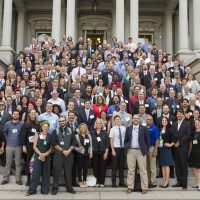 A crowd stands on the white house steps.